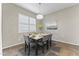 Dining room with large window, chandelier and seating for six guests at 2229 N Beverly Pl, Buckeye, AZ 85396