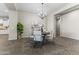 Elegant dining room with modern chandelier, seating for four and decorative accents at 2229 N Beverly Pl, Buckeye, AZ 85396