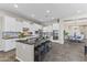 Bright kitchen with large center island, stainless appliances and adjacent dining area at 2229 N Beverly Pl, Buckeye, AZ 85396