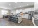 Beautiful kitchen features a center island with seating, stainless steel appliances, and white cabinetry at 2229 N Beverly Pl, Buckeye, AZ 85396
