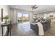Comfortable living room with a ceiling fan, slider to the pool and contemporary furniture at 2229 N Beverly Pl, Buckeye, AZ 85396