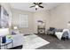 Cozy living room featuring stylish furniture, a ceiling fan, an area rug, and neutral tones at 2229 N Beverly Pl, Buckeye, AZ 85396
