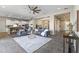 Spacious open concept living room showcasing large sectional with a view to the kitchen at 2229 N Beverly Pl, Buckeye, AZ 85396