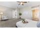 Spacious main bedroom features a ceiling fan, neutral color palette, and a decorative bed tray at 2229 N Beverly Pl, Buckeye, AZ 85396