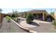 Landscaped backyard with a brick patio and gravel at 14133 S 179Th Ave, Goodyear, AZ 85338