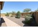 Landscaped backyard with a brick pathway and gravel at 14133 S 179Th Ave, Goodyear, AZ 85338