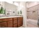 Clean bathroom with double vanity and tiled shower/tub at 14133 S 179Th Ave, Goodyear, AZ 85338
