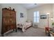 Cozy bedroom with twin bed, wooden armoire, and window shutters at 14133 S 179Th Ave, Goodyear, AZ 85338