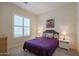 Spacious bedroom with purple bedding and large window at 14133 S 179Th Ave, Goodyear, AZ 85338
