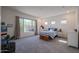 Spacious bedroom with large windows, plush carpeting, and a sitting area at 14133 S 179Th Ave, Goodyear, AZ 85338