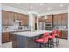 Modern kitchen with island, stainless steel appliances, and wood cabinets at 14133 S 179Th Ave, Goodyear, AZ 85338