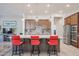 Kitchen boasts an island with red stools and stainless steel appliances at 14133 S 179Th Ave, Goodyear, AZ 85338