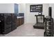 Modern laundry room with front loading washer and dryer, sink, weights, and a treadmill for exercising while you wash at 14133 S 179Th Ave, Goodyear, AZ 85338