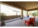 Covered patio with seating area, pathway, and desert landscaping at 14133 S 179Th Ave, Goodyear, AZ 85338
