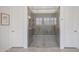 Large walk-in shower with glass enclosure and hexagon tile at 14133 S 179Th Ave, Goodyear, AZ 85338