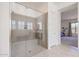 Modern walk-in shower with glass enclosure and built-in seat at 14133 S 179Th Ave, Goodyear, AZ 85338