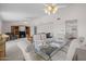 Open-concept dining and living room with neutral paint, plush carpeting, and ceiling fans at 1729 Leisure World --, Mesa, AZ 85206