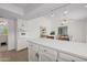 Bright kitchen with white cabinetry, quartz counters, stainless oven, and eat-in dining area at 1729 Leisure World --, Mesa, AZ 85206
