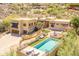 Stunning aerial view of the property showcasing the pool, outdoor seating, and beautiful landscaping at 7002 N Hillside Dr, Paradise Valley, AZ 85253