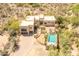 Aerial view of a desert home with lush foliage and a luxurious pool at 7002 N Hillside Dr, Paradise Valley, AZ 85253