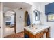 Cozy bathroom with colorful tiled sink and terra cotta floors; bedroom is visible through the archway at 7002 N Hillside Dr, Paradise Valley, AZ 85253