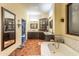 Spacious bathroom with tile floors, a soaking tub, and vanity area offering a luxurious and relaxing space at 7002 N Hillside Dr, Paradise Valley, AZ 85253