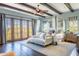 Bright bedroom with canopy bed, wood floors, ceiling fan, and doors leading to an outdoor view providing a peaceful sanctuary at 7002 N Hillside Dr, Paradise Valley, AZ 85253
