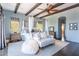 Well-lit bedroom featuring beamed ceilings, a seating area, a canopy bed, and dark wood floors, creating a cozy atmosphere at 7002 N Hillside Dr, Paradise Valley, AZ 85253