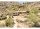 Two-story stucco home with a two-car garage, pool, and brick driveway at 7002 N Hillside Dr, Paradise Valley, AZ 85253