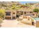 Two-story stucco home with a two-car garage, pool, and brick driveway at 7002 N Hillside Dr, Paradise Valley, AZ 85253