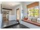 Bright hallway with a window seat, dark wood floors, and recessed lighting create a cozy and inviting space at 7002 N Hillside Dr, Paradise Valley, AZ 85253