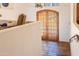 Hallway featuring wood doors, tile flooring, and neutral walls, creating a warm and inviting ambiance at 7002 N Hillside Dr, Paradise Valley, AZ 85253