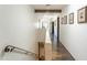 Bright hallway with hardwood floors, white walls, and access to multiple rooms at 7002 N Hillside Dr, Paradise Valley, AZ 85253