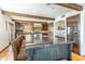 Gourmet kitchen with an island, wooden beams, modern appliances, and a wine refrigerator at 7002 N Hillside Dr, Paradise Valley, AZ 85253