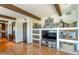 Comfortable living room with wooden beams, built-in shelves, and a view to the kitchen at 7002 N Hillside Dr, Paradise Valley, AZ 85253