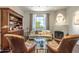 Cozy living room with fireplace, hardwood floors, and a view of the outdoors at 7002 N Hillside Dr, Paradise Valley, AZ 85253
