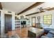 Bright living room with wooden beams, terracotta tile floors, and comfortable furnishings at 7002 N Hillside Dr, Paradise Valley, AZ 85253