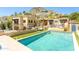 Backyard view featuring a sparkling pool, outdoor seating, and manicured landscaping, perfect for relaxation at 7002 N Hillside Dr, Paradise Valley, AZ 85253
