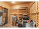 Well-lit storage room with wooden wine racks and ample space for organization at 7002 N Hillside Dr, Paradise Valley, AZ 85253