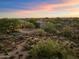 Aerial view of a luxurious house and expansive desert landscape at 7628 E Mary Sharon Dr, Scottsdale, AZ 85266