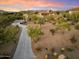 Luxury home nestled on a large lot with a long driveway and desert landscaping at 7628 E Mary Sharon Dr, Scottsdale, AZ 85266
