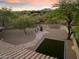 Landscaped backyard with a flagstone path, fire pit, and artificial turf at 7628 E Mary Sharon Dr, Scottsdale, AZ 85266