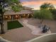 Relaxing backyard with artificial turf, flagstone path, and fire pit area at 7628 E Mary Sharon Dr, Scottsdale, AZ 85266