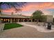 Spacious backyard oasis with artificial turf, flagstone path, and fire pit at 7628 E Mary Sharon Dr, Scottsdale, AZ 85266