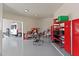 Workshop area in garage, go-kart, workbench, and storage shelving at 7628 E Mary Sharon Dr, Scottsdale, AZ 85266
