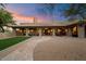 Luxury home with covered patio, stone pathway, and desert landscaping at 7628 E Mary Sharon Dr, Scottsdale, AZ 85266