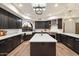 Spacious kitchen with island, stainless steel appliances, and dark cabinetry at 7628 E Mary Sharon Dr, Scottsdale, AZ 85266