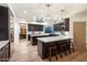 Modern kitchen with large island, white countertops, and dark cabinets at 7628 E Mary Sharon Dr, Scottsdale, AZ 85266