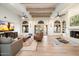 Spacious living room with hardwood floors, a fireplace, and large windows at 7628 E Mary Sharon Dr, Scottsdale, AZ 85266