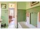 Bathroom with mint green tile, bathtub, and view of bedroom at 363 E Monte Vista Rd, Phoenix, AZ 85004